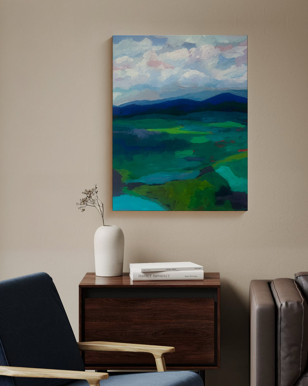 Abstract landscape painting on a wall above a wooden side table with a vase and books. Lifestyle mockup. Shop original landscape artwork and contemporary painting by Terry Pesso that blends abstraction, memory, and natural rhythm. These expressive works use layered color and motion to create dramatic wall art decor and are ideal for framed art and framed wall art presentation.
