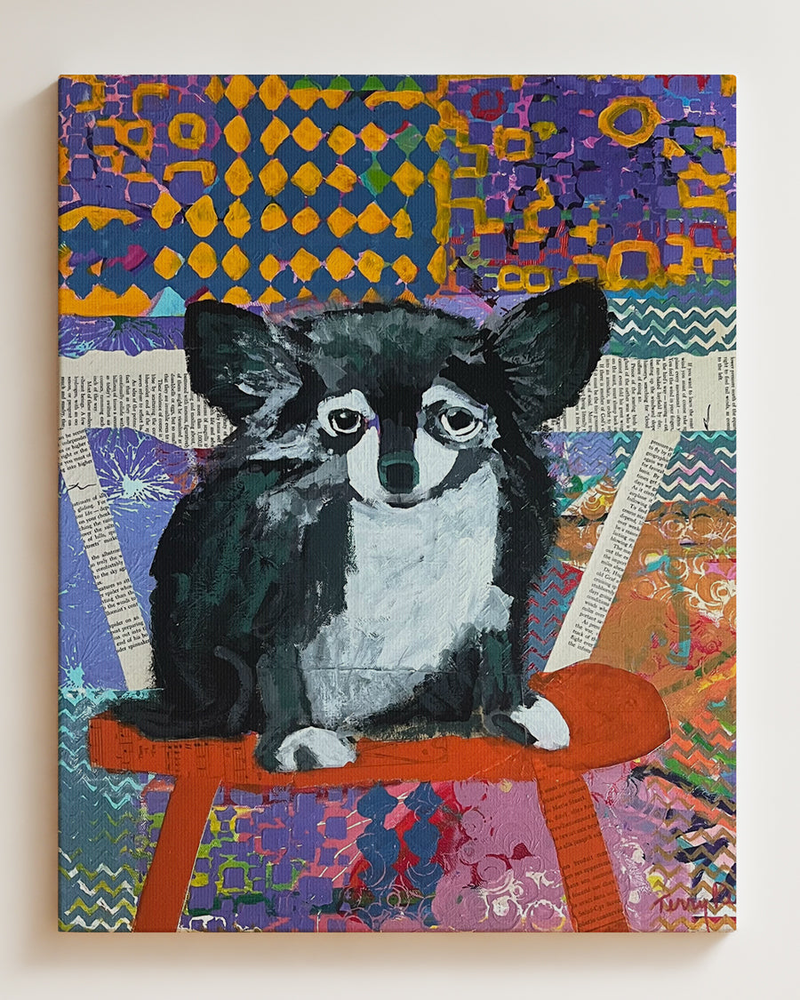Colorful artwork of a dog on a bench with abstract patterns. Full view, hanging on wall. "Devoted" is an original mixed media painting that captures the soulful presence of a dog against a richly textured, patterned background. Layers of color, collage, and brushwork combine to create depth and emotion, blending realism with abstract design. The expressive eyes and thoughtful pose bring warmth and personality to the piece, making it a perfect addition for dog lovers and collectors of contemporary art.