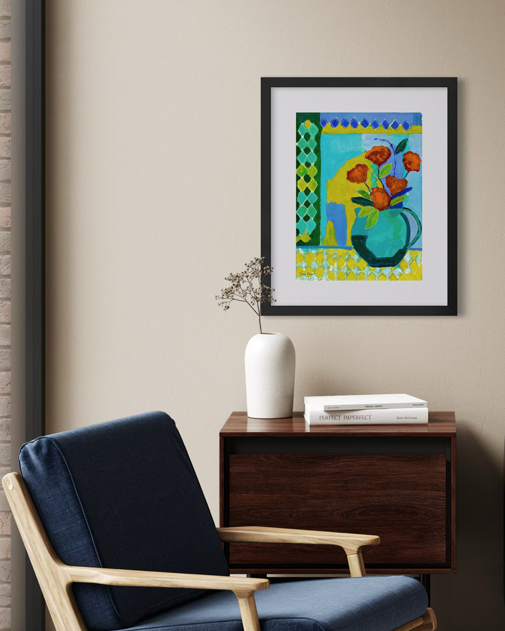 Framed abstract art piece on a wall above a wooden side table with a vase and books. Lifestyle mockup. An original still life artwork and contemporary painting by Terry Pesso inspired by everyday objects, vessels, and quiet moments. These expressive works elevate ordinary subjects into refined wall art decor and are suitable for framed art and framed wall art.
