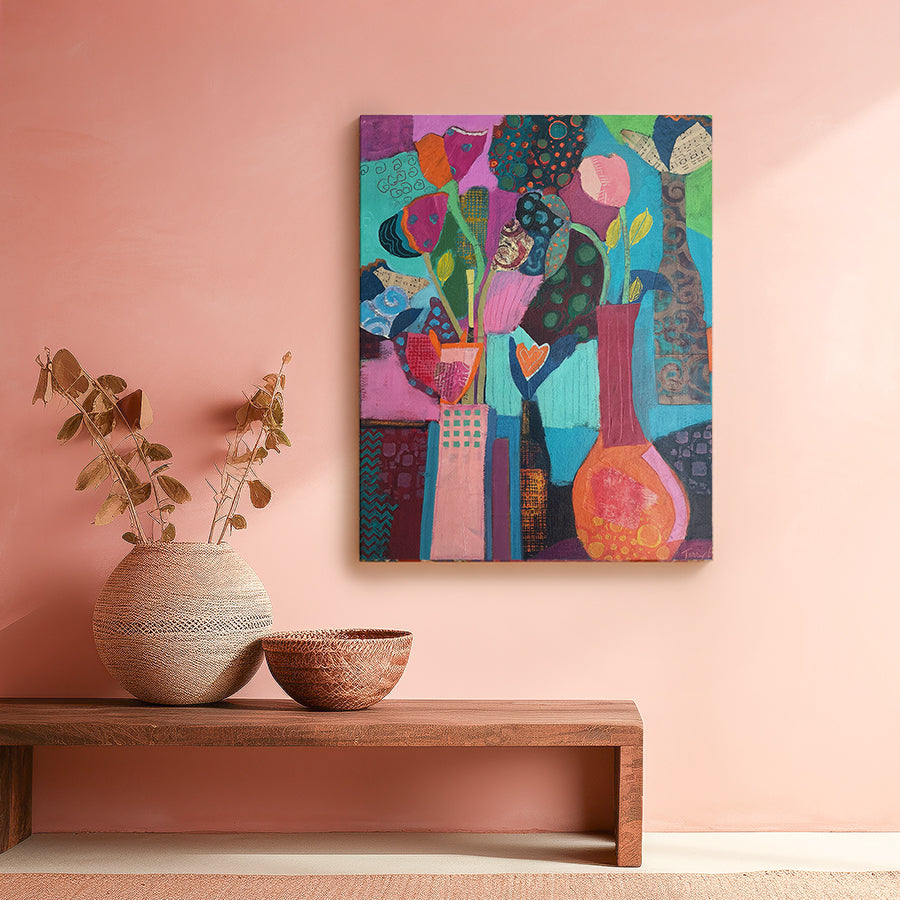 Colorful abstract painting on a pink wall with decorative vases and a wooden bench. Original floral artwork and contemporary painting by Terry Pesso featuring expressive color and layered design. Created for wall art decor and suitable for framed art and framed wall art.