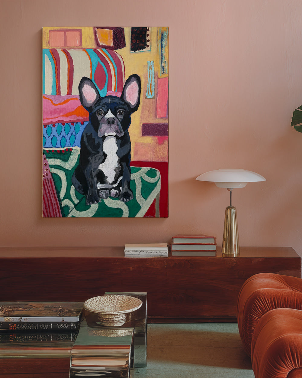 Colorful abstract painting of a black and white dog on a wall in a living room. Lifestyle mockup view. "I'm Waiting for You" is an original mixed media painting that captures the unmistakable charm of a French Bulldog. Set against a vibrant patterned backdrop of coral, teal, and gold, this piece radiates warmth and personality. The expressive face and upright ears bring the dogÕs character to life, while the bold use of color and texture adds a modern twist. A playful yet heartfelt dog artwork that brighten