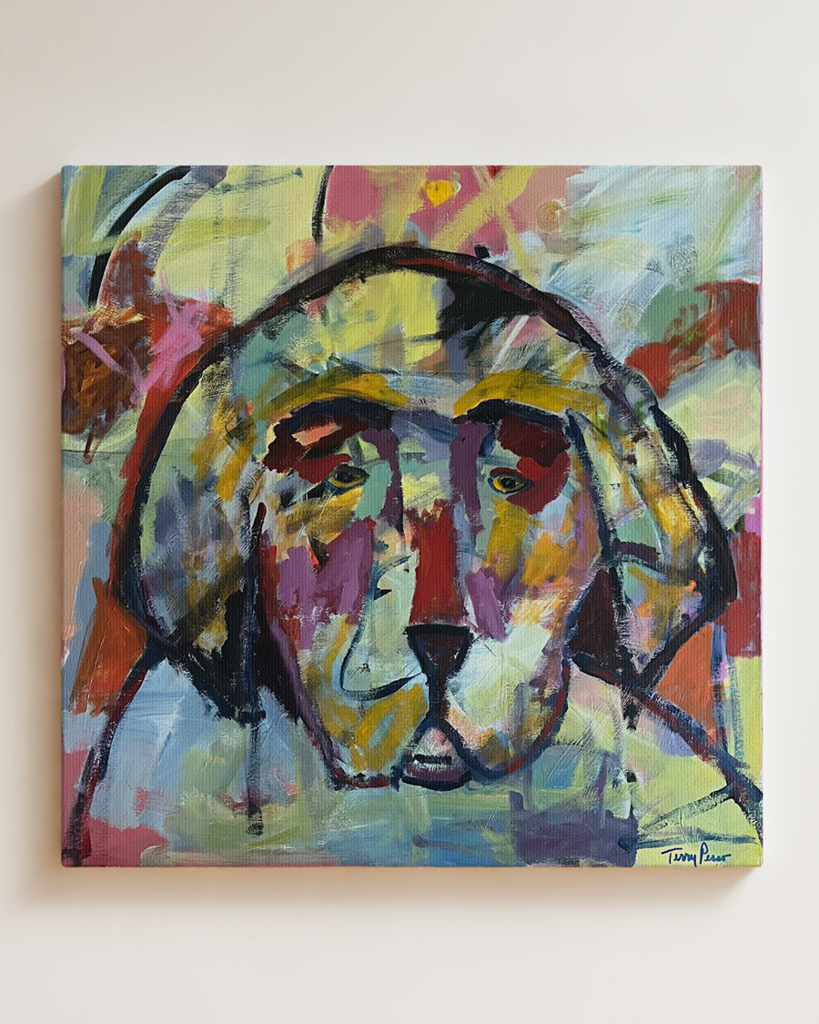Abstract painting of a dog's face with vibrant colors on a white wall. Full view. "I'm With You" is an original acrylic painting that captures the soulful presence of a dog through bold color and expressive brushwork. Layers of gold, violet, and coral blend together in a composition that feels both modern and deeply emotional. This original artwork celebrates the quiet bond, warmth, and companionship that dogs bring into our lives.