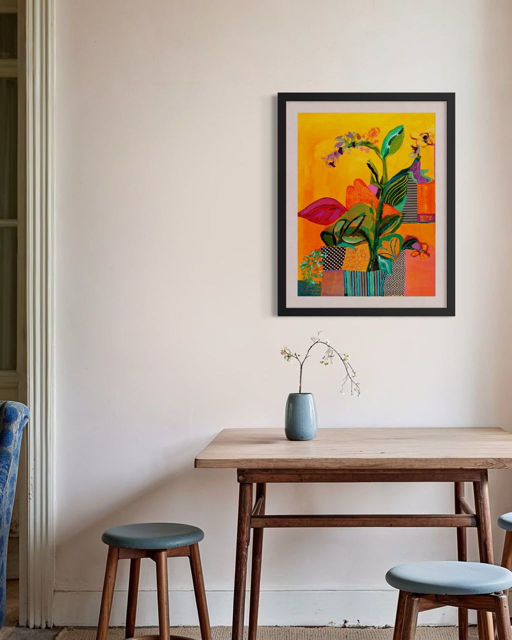 Colorful abstract painting on a wall above a wooden table with stools. Lifestyle mockup. Shop original floral and botanical artwork and contemporary painting by Terry Pesso inspired by blooms, leaves, and organic form. These vibrant mixed media paintings bring fresh energy to wall art decor and are ready for framed art and framed wall art display.