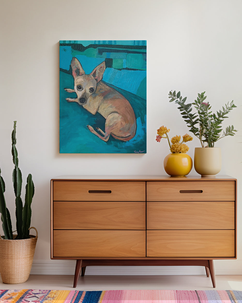 Lifestyle mockup view of painting of a chihuahua dog with a blue background on canvas. Original dog artwork and contemporary dog painting created in mixed media and acrylic by Terry Pesso. These expressive works are perfect for collectors seeking playful wall art decor with emotional impact. Each original painting is suitable for framed art and framed wall art once professionally mounted.