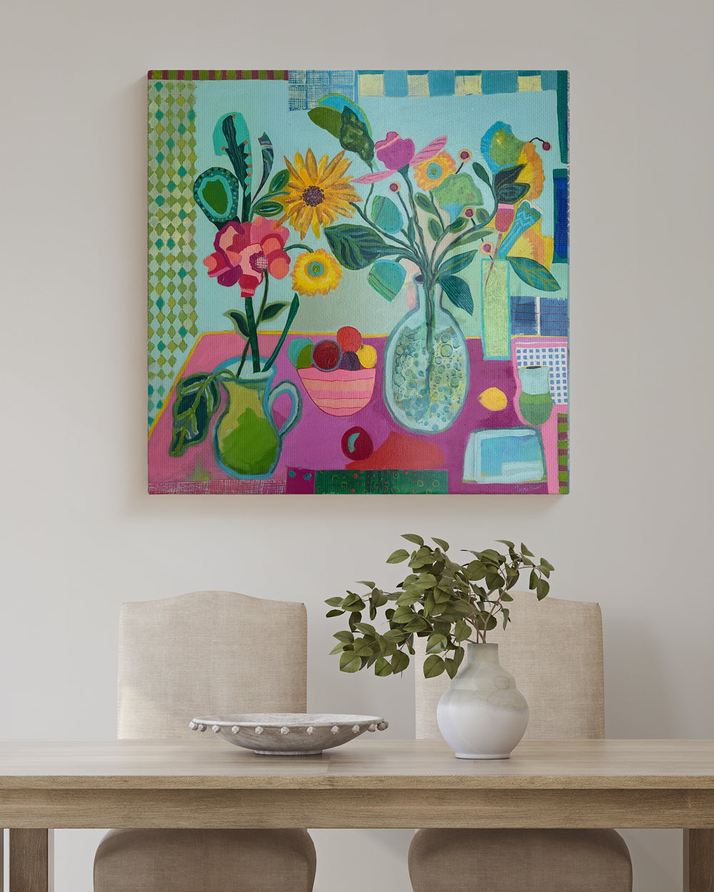 Florals on a table. An original still life artwork and contemporary painting on square canvas, by Terry Pesso inspired by everyday objects, vessels, and quiet moments. These expressive works elevate ordinary subjects into refined wall art decor and are suitable for framed art and framed wall art. Lifestyle mockup view.