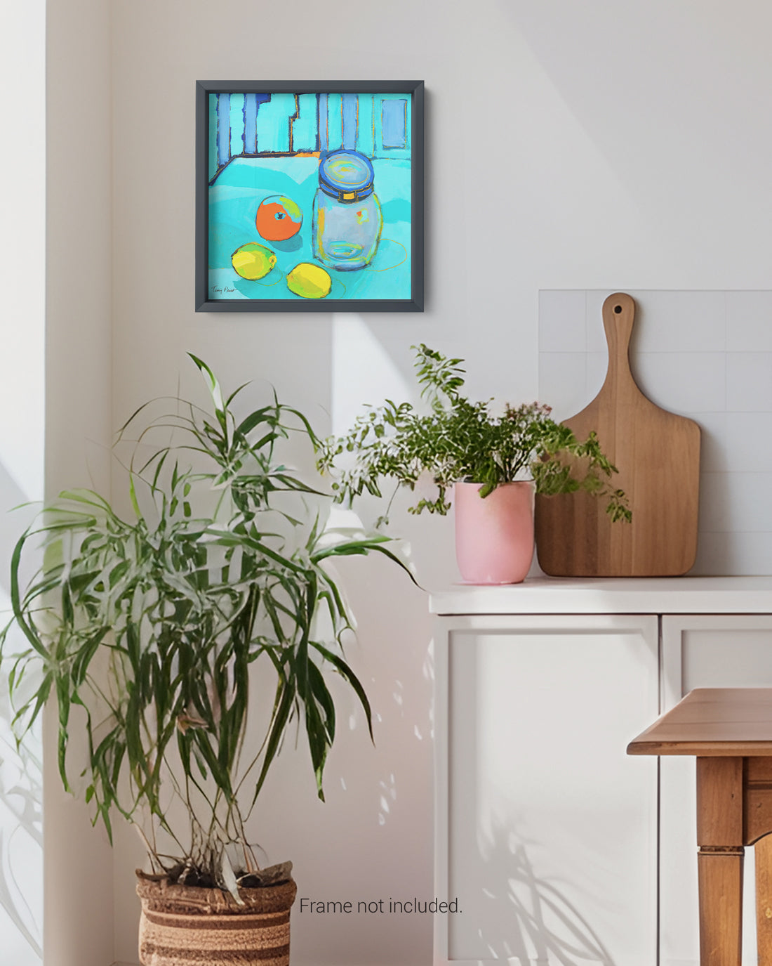 Framed artwork on a wall above a table with plants and a cutting board. Lifestyle mockup shot. An original still life artwork and contemporary painting by Terry Pesso inspired by everyday objects, vessels, and quiet moments. These expressive works elevate ordinary subjects into refined wall art decor and are suitable for framed art and framed wall art.