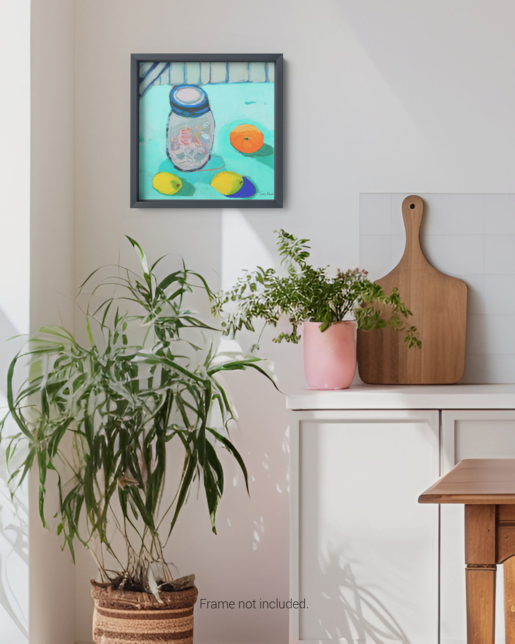 Framed artwork on a wall with plants and a cutting board below. Lifestyle shot in a room. An original still life artwork and contemporary painting by Terry Pesso inspired by everyday objects, vessels, and quiet moments. These expressive works elevate ordinary subjects into refined wall art decor and are suitable for framed art and framed wall art.