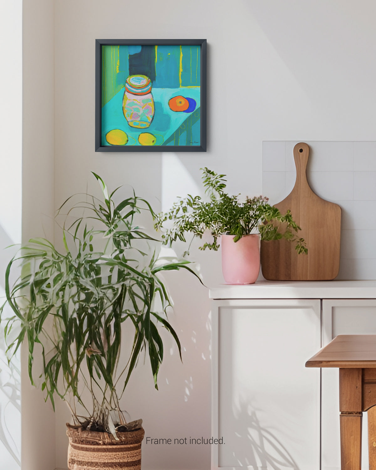 Framed artwork on a wall with plants and a cutting board below. An original still life artwork and contemporary painting by Terry Pesso inspired by everyday objects, vessels, and quiet moments. These expressive works elevate ordinary subjects into refined wall art decor and are suitable for framed art and framed wall art.