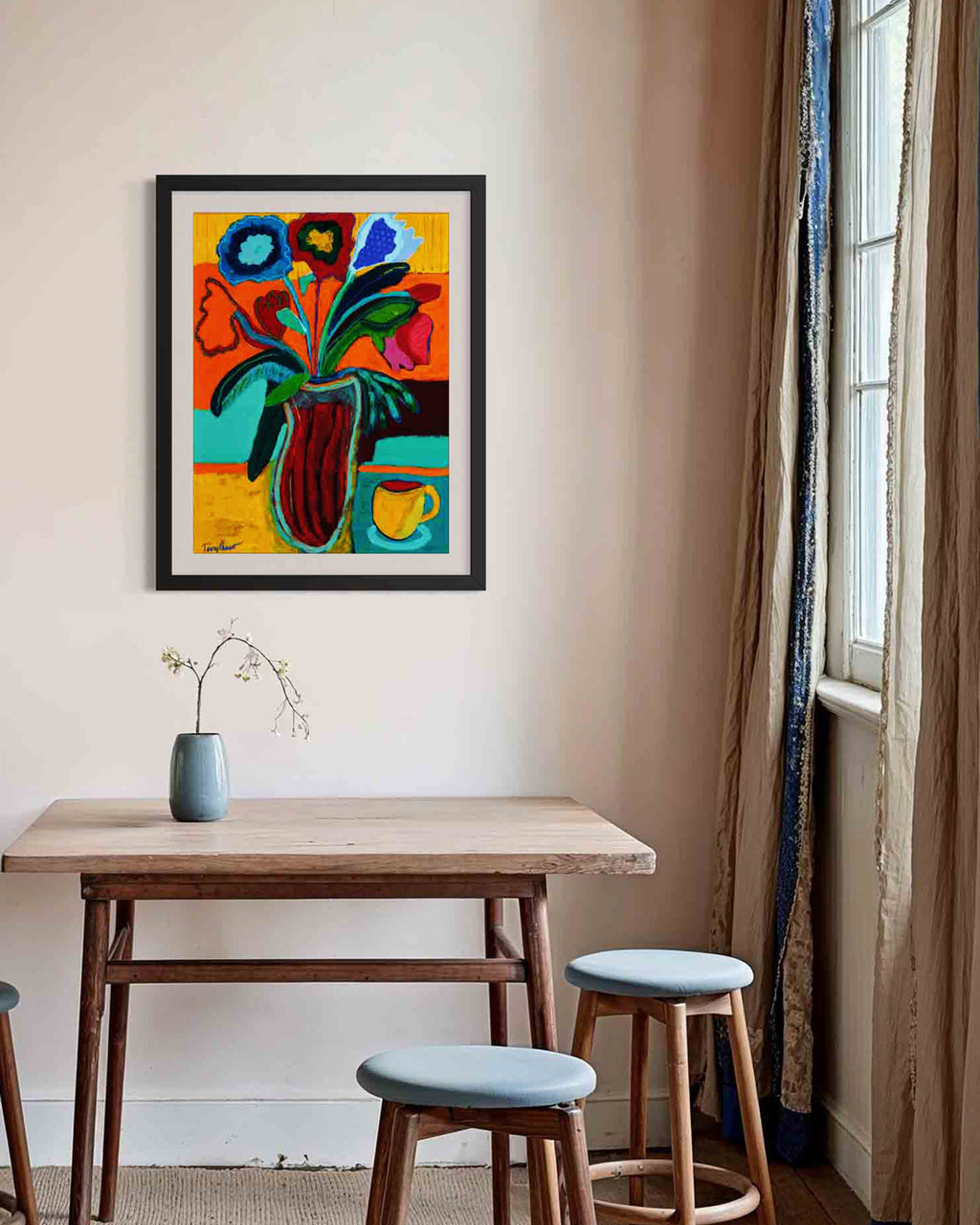 Colorful abstract painting on a wall above a wooden table with stools. Mockup of artwork in lifestyle shot. An original still life artwork and contemporary painting by Terry Pesso inspired by everyday objects, vessels, and quiet moments. These expressive works elevate ordinary subjects into refined wall art decor and are suitable for framed art and framed wall art.